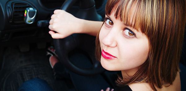 Woman at steering wheel, car insurance for women